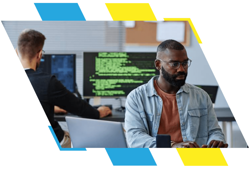two people working in an it office working on coding