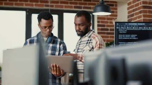 employees using laptop to access cloud backup for business