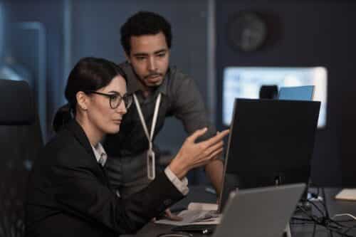 employee pointing to computer showing layers of security